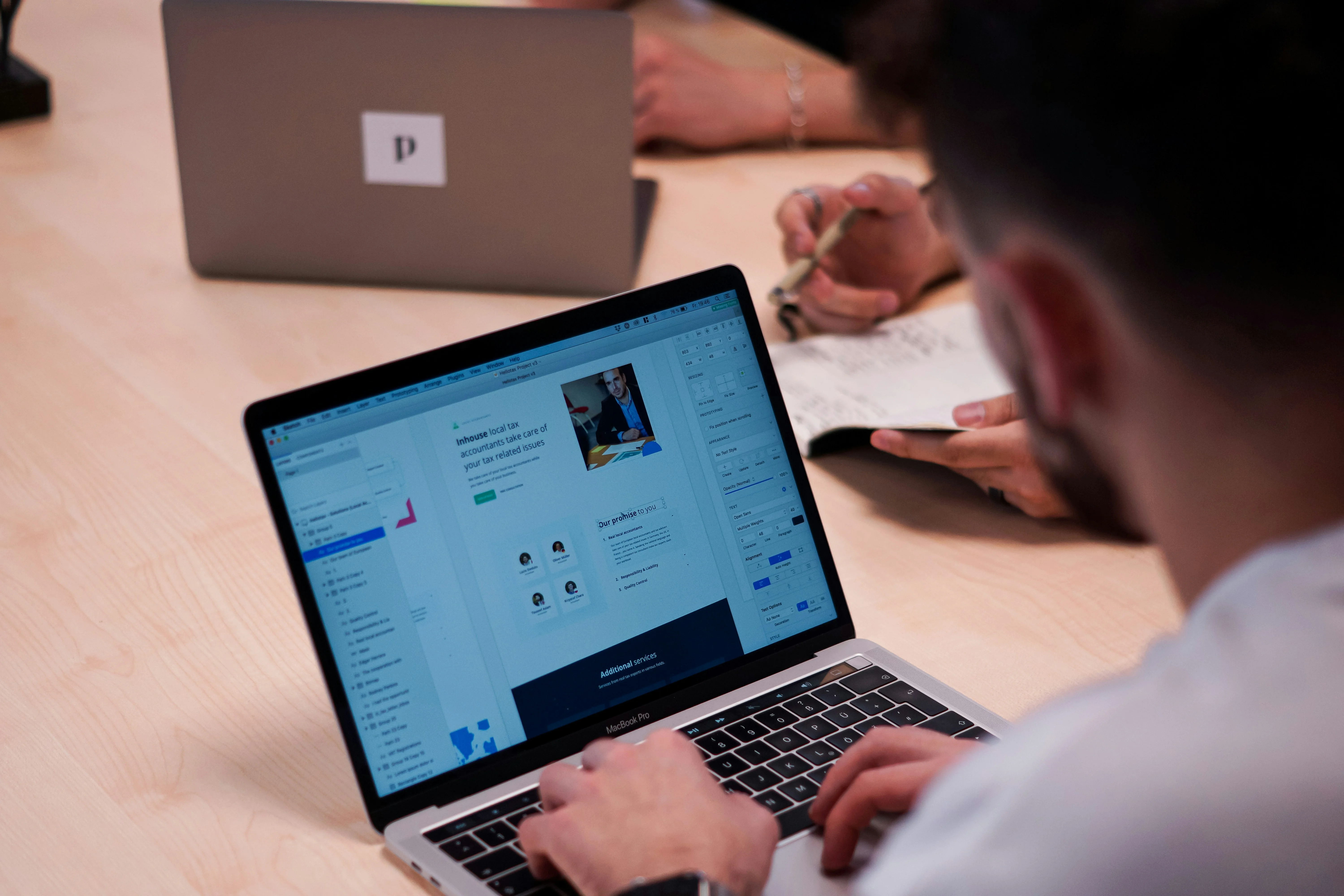 Designer focused on a polished UI while analytics report sits unreviewed beside it, showing UX craft disconnected from conversion outcomes