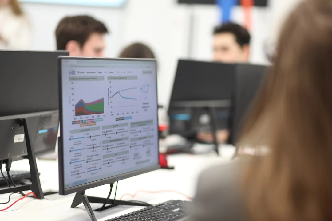 Group of people working together on computers in a bright collaborative office space